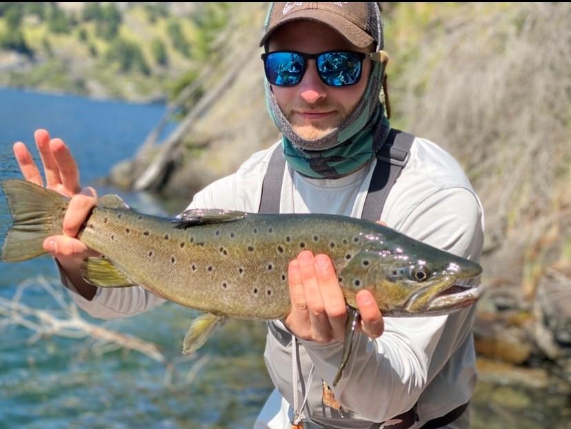 Vail Valley Angles guide Ethan Ledford showcasing a beautiful brown trout caught while fishing in the Vail Valley.